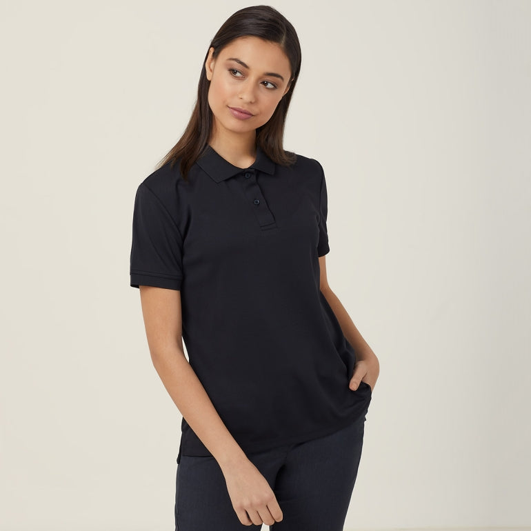 A woman wearing a black short sleeve polo shirt with a collar, in a classic fit with a two-button placket and ribbed sleeve cuffs.