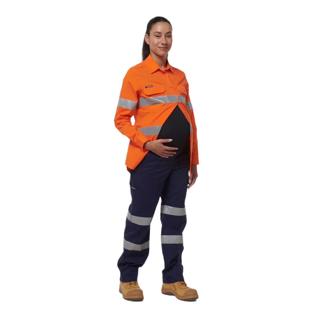 Person wearing an orange safety shirt and navy pants with reflective stripes on a white background