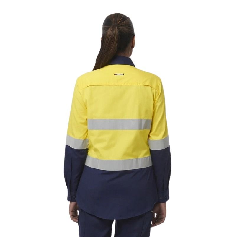 Person wearing a yellow and navy high-visibility work jacket on a white background
