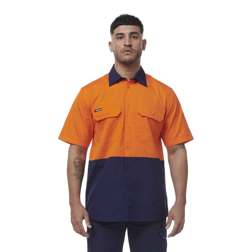 Man wearing an orange and navy work shirt on a white background
