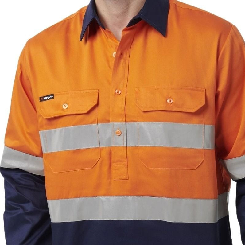Man in orange spliced shirt with reflective tape brand name king gee on white background with two front pockets and half button placard