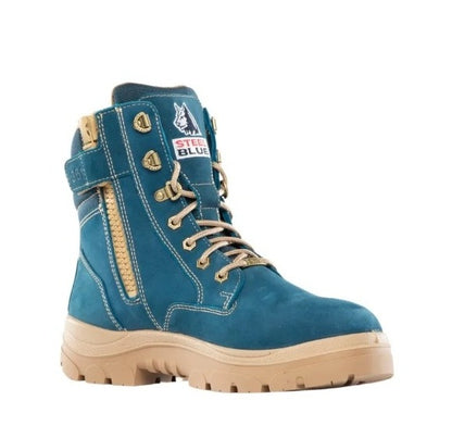 Blue work boot with tan laces and sole on a white background