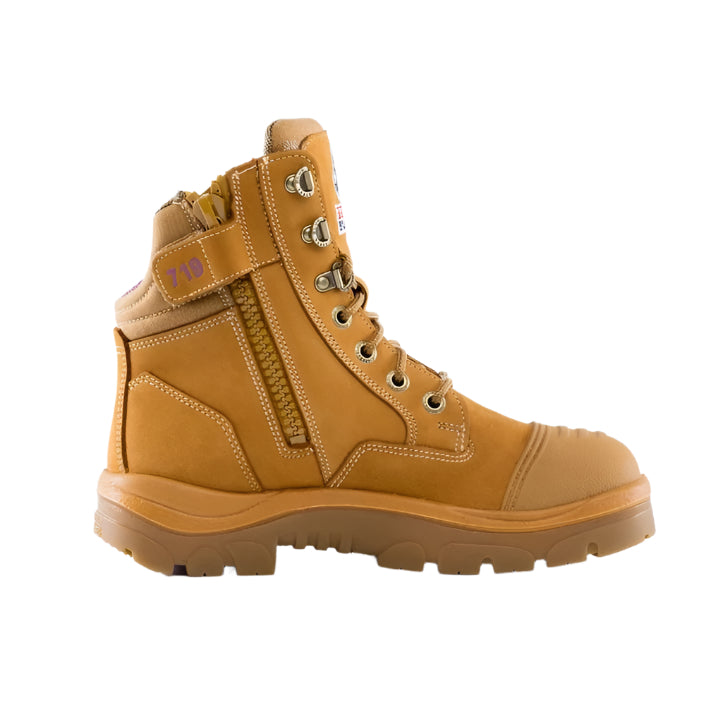 A wheat coloured Steel Blue ladies safety boot with a scalloped collar, lace-up front, and side zip, designed for comfort and protection.