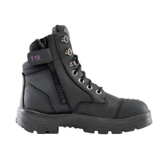 A black Steel Blue ladies safety boot with a scalloped collar, padded tongue, and side zipper. It features a lace-up front and a steel toe cap.