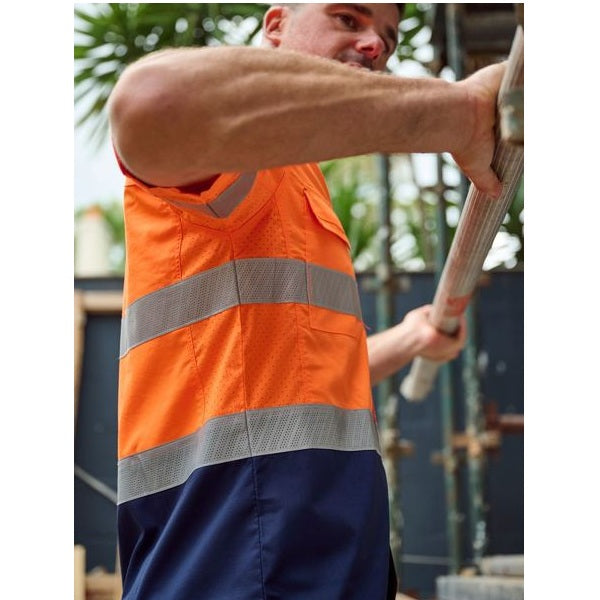 Person wearing an orange high-visibility vest holding a tool outdoors.