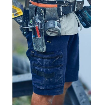 Person wearing a tool belt with various tools and equipment.