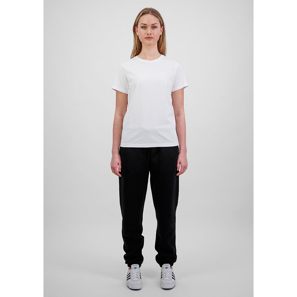 Person wearing a plain white t-shirt and black pants on a light gray background