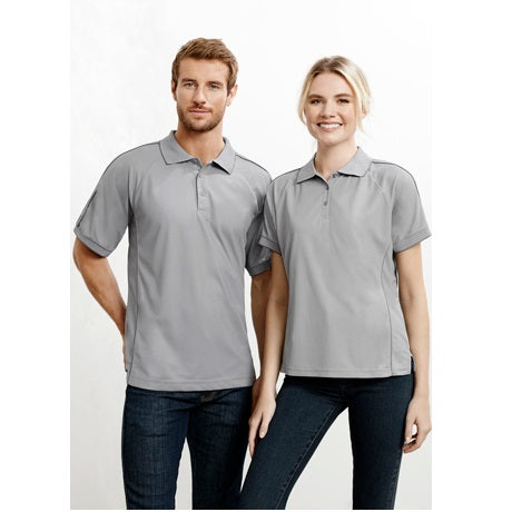 A man and a woman standing side by side, both wearing matching Biz Collection ladies' resort polo with a collared neckline and short sleeves.