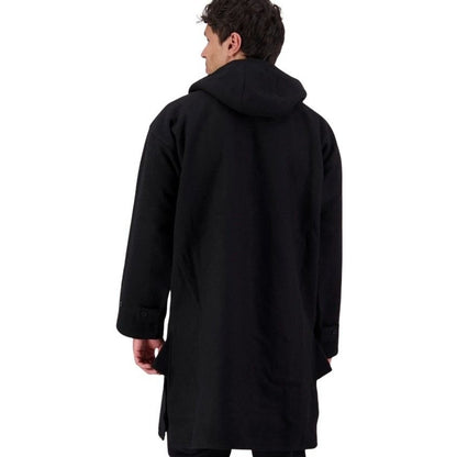 Person wearing a black coat on a white background
