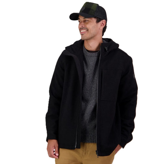 Man wearing a black jacket, gray sweater, and cap on a white background