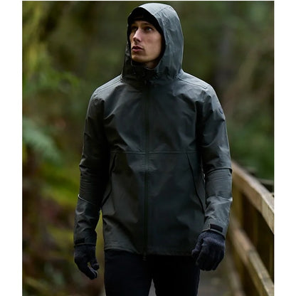 Person wearing a dark raincoat in a forest setting