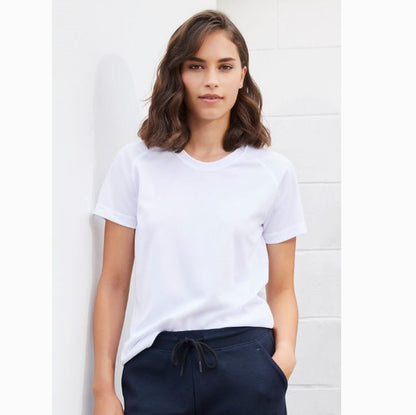 A woman wearing a white Biz Collection crew neck t-shirt with short sleeves, paired with dark pants.