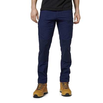 Person wearing navy pants and brown hiking boots on a white background