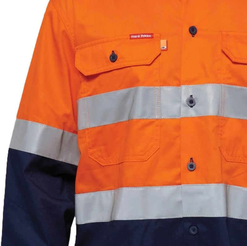 Close-up of a high-visibility work shirt with orange, gray, and navy colors.