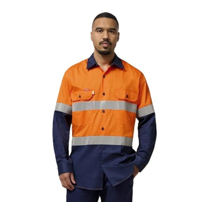 Person wearing an orange and navy high-visibility work shirt on a white background