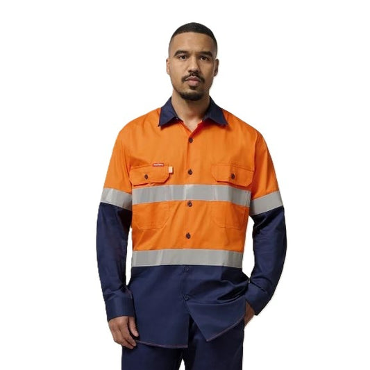 Person wearing an orange and navy high-visibility work shirt on a white background
