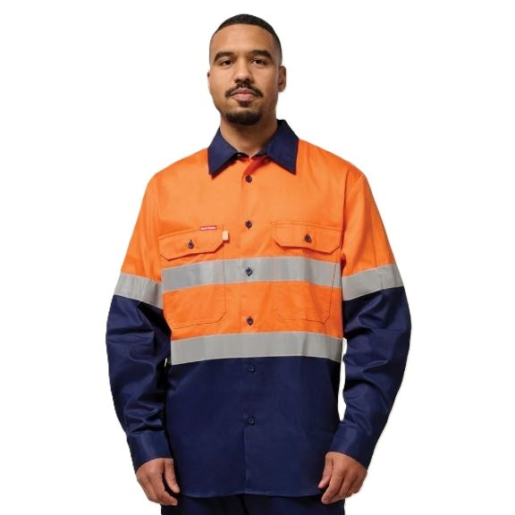Person wearing a high-visibility orange and navy work shirt on a white background