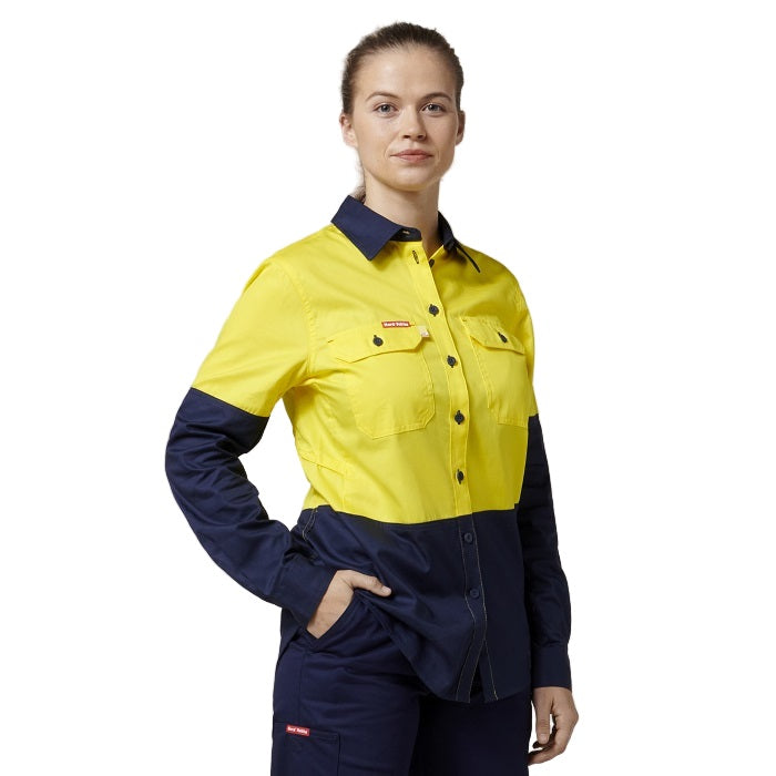 Person wearing a yellow and navy work shirt on a white background