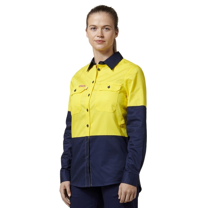 Person wearing a yellow and navy work shirt on a white background