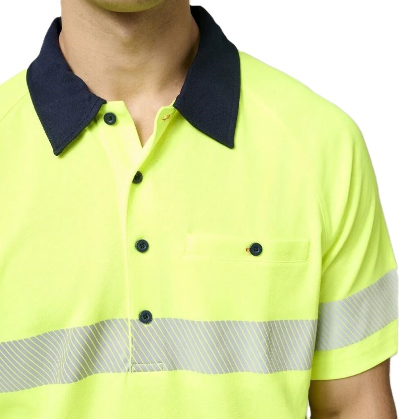 Close-up of a person wearing a bright yellow safety shirt with reflective stripes on a white background