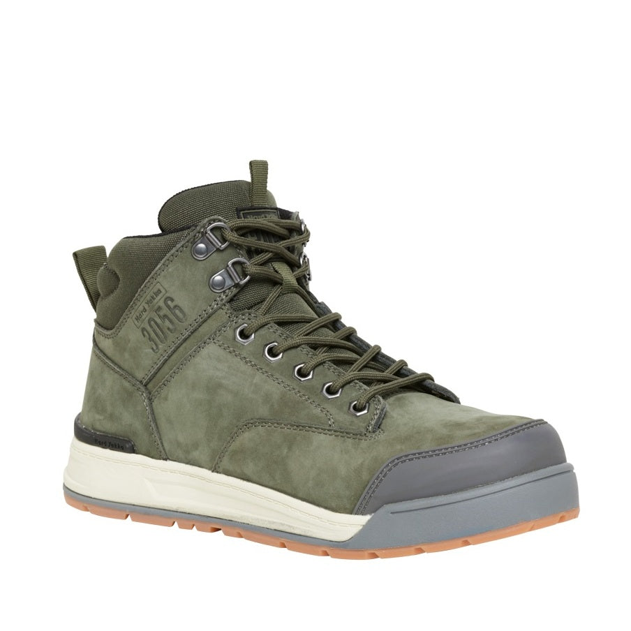 Green hiking boot with a white sole on a white background