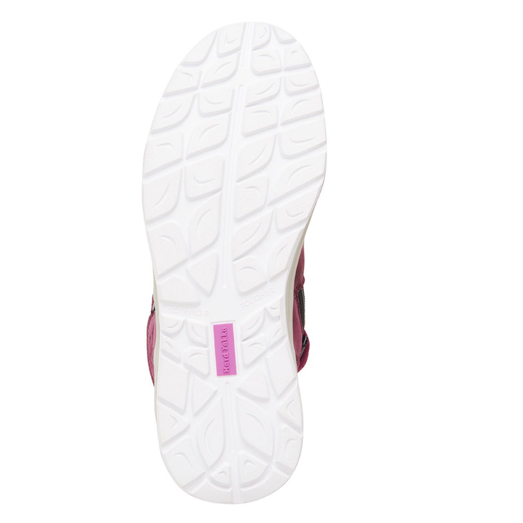 White sole of a shoe with a pink logo on a white background