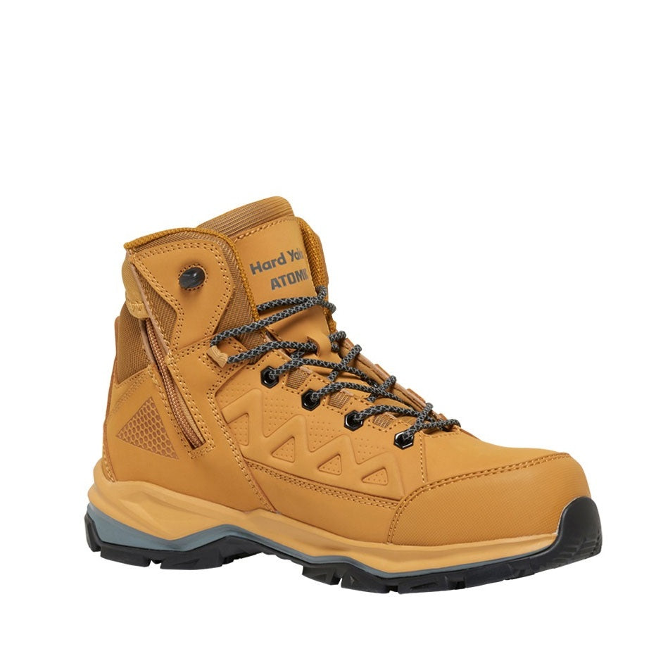 Yellow hiking boot with black laces on a white background