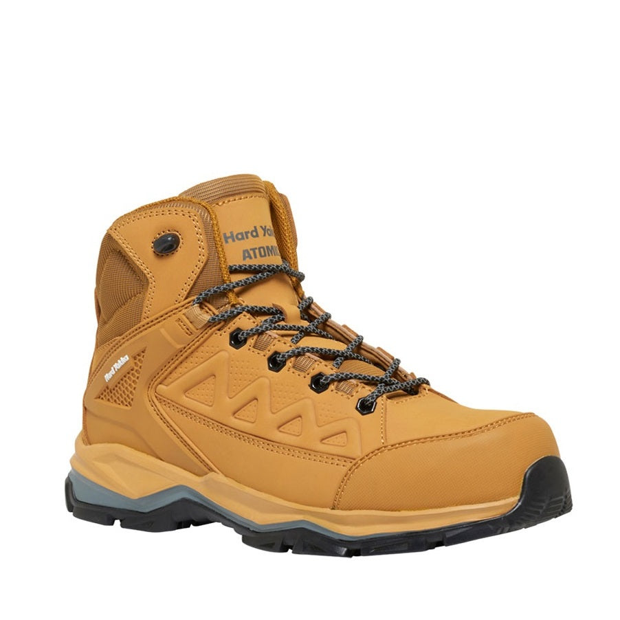 Yellow hiking boot with black laces on a white background