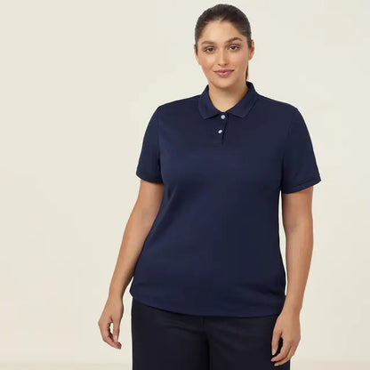 Professional woman wearing an NNT CATU58 navy blue polo shirt against a beige background