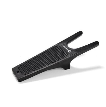 A black Yaktrax Boot Jack designed to remove boots with ease, featuring a unique shape and polypropylene construction.