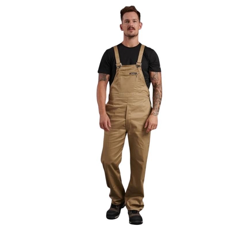 Man wearing tan bib overalls on a white background