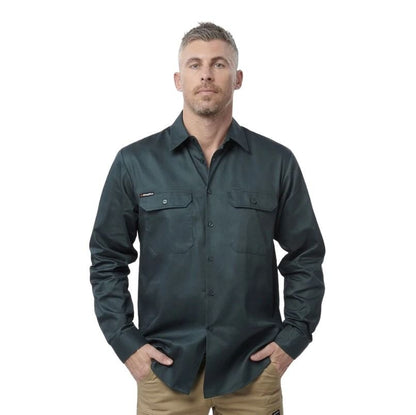 Man wearing a dark green shirt with pockets on a white background