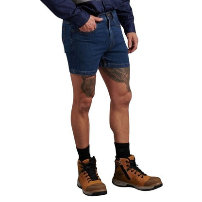 Person wearing blue denim shorts and brown boots on a white background