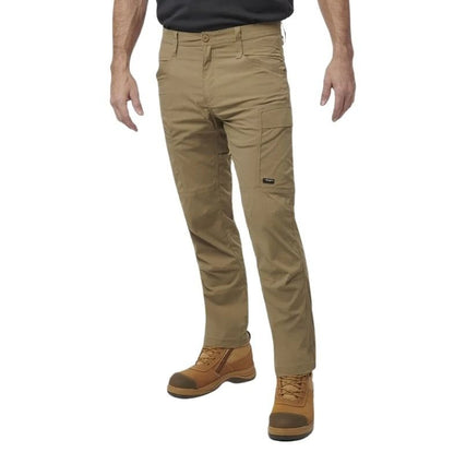 Person wearing beige pants and brown boots on a white background