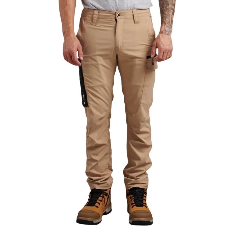 Person wearing beige pants and brown boots on a white background