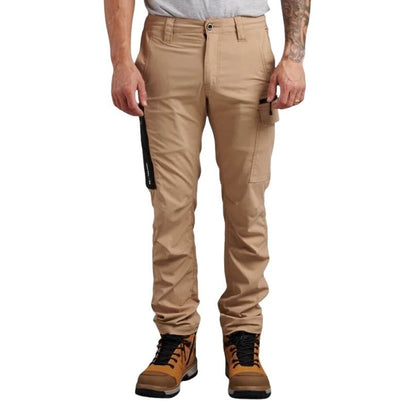 Person wearing beige pants and brown boots on a white background