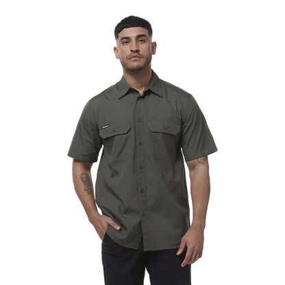 Man wearing a green short-sleeve shirt on a white background