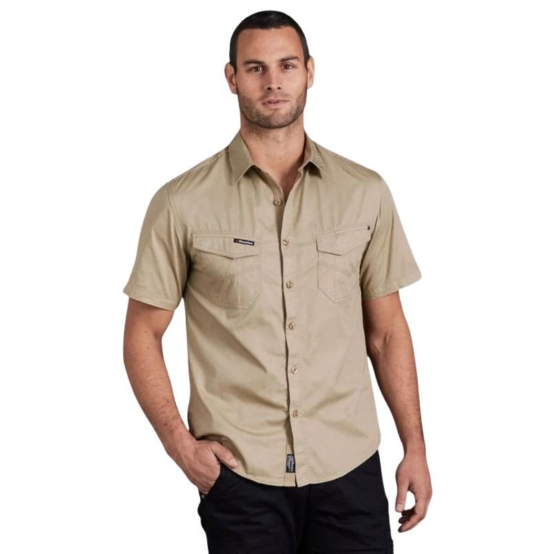 Man wearing a beige short-sleeve shirt on a white background