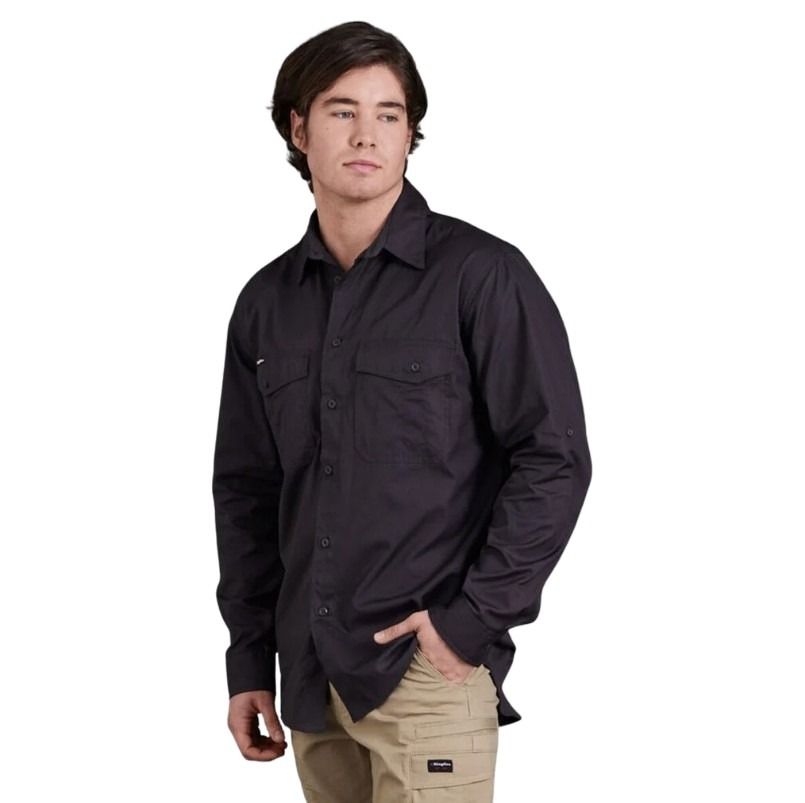Man wearing a black long-sleeve shirt and beige pants on a white background