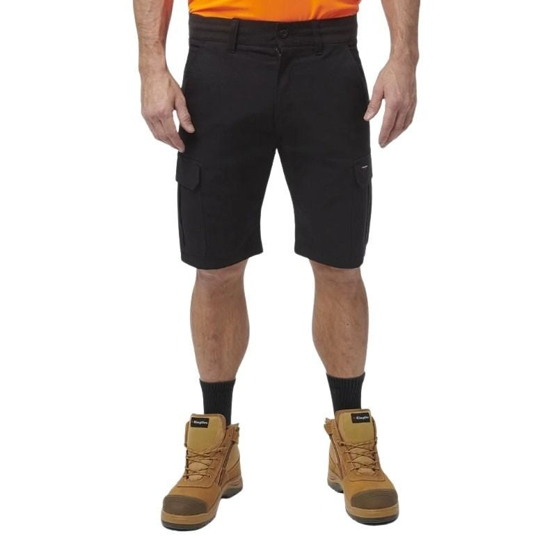 Person wearing black cargo shorts and brown boots on a white background