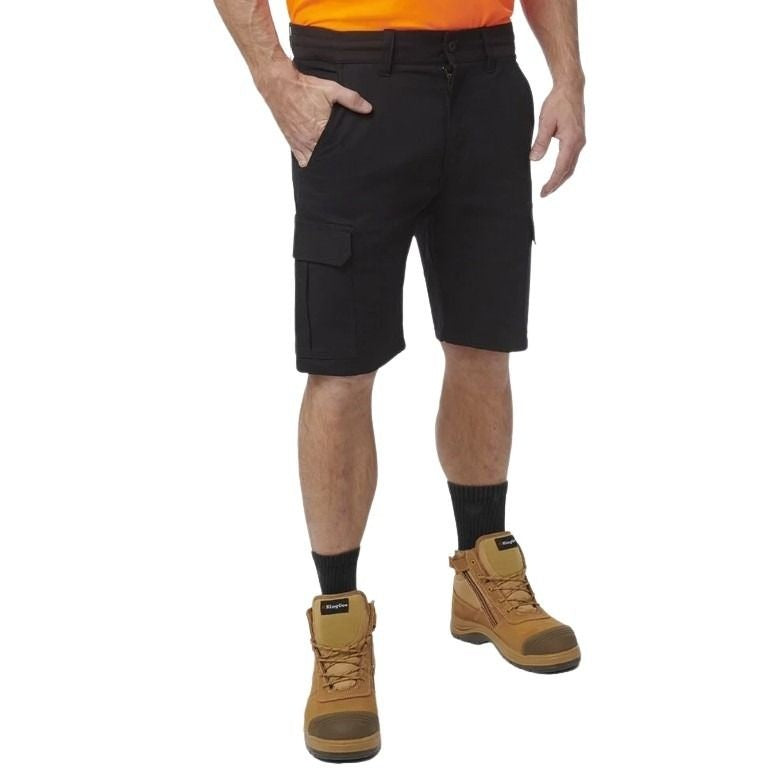 Person wearing black cargo shorts, orange shirt, and brown boots on a white background
