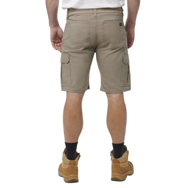 Person wearing beige cargo shorts on a white background