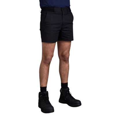 Person wearing black shorts and black boots on a white background