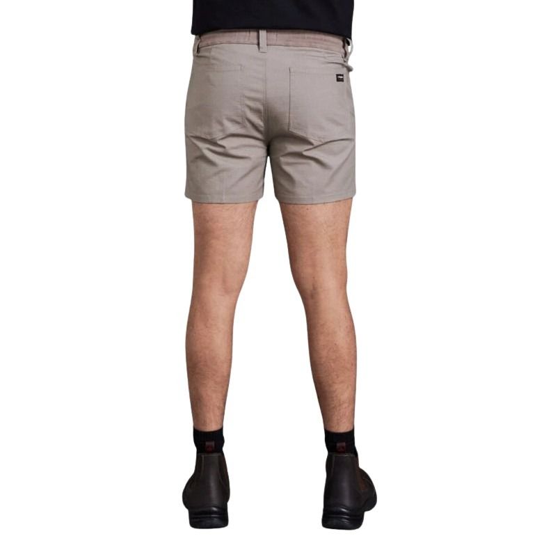 Person wearing beige shorts on a white background