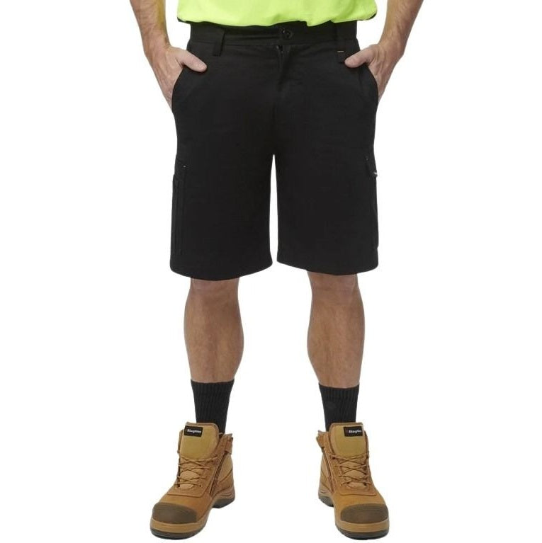 Person wearing black shorts, brown boots, and a high-visibility shirt on a white background
