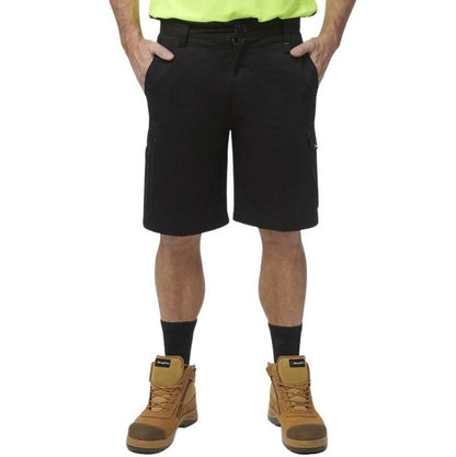 Person wearing black shorts, brown boots, and a high-visibility shirt on a white background