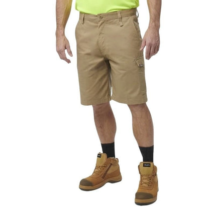 Person wearing beige shorts and brown boots on a white background