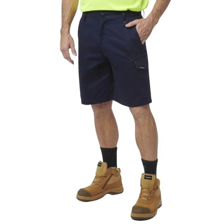 Person wearing navy shorts, yellow shirt, black socks, and brown work boots on a white background