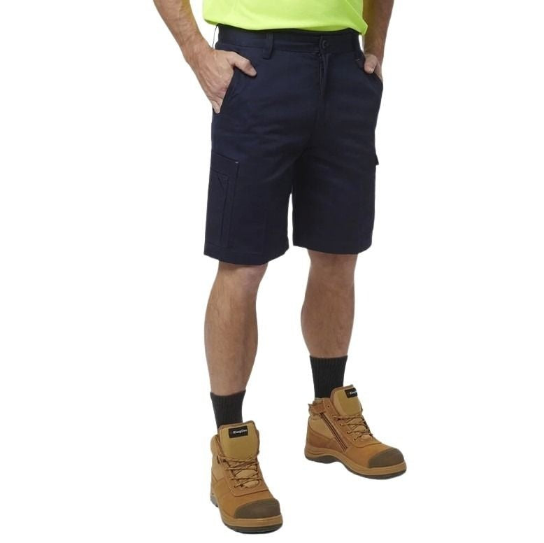 Person wearing navy shorts, yellow shirt, and brown boots on a white background