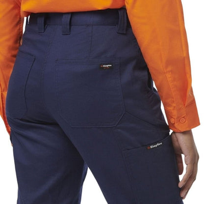 Navy pants with King Gee logo worn by a person in an orange shirt on a white background